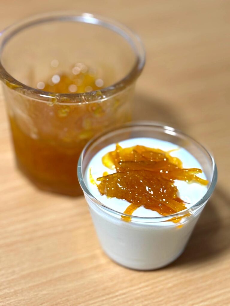 Yogurt topped with Amanatsu marmalade, with a jar of homemade marmalade in the background