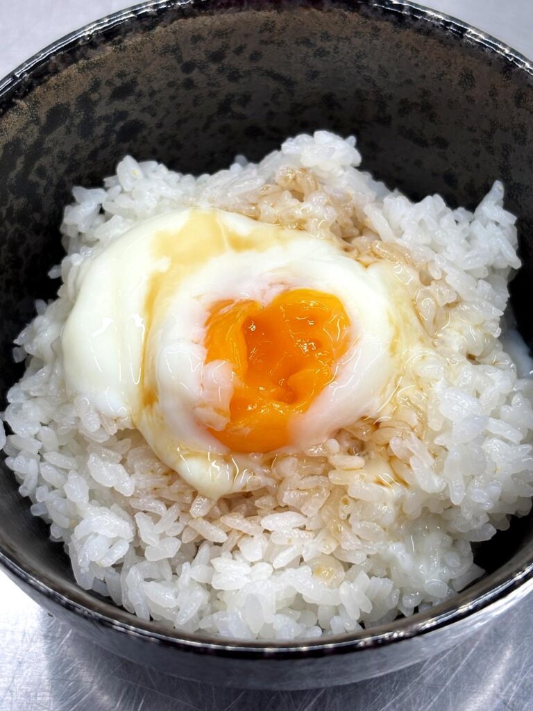 Rice topped with soy sauce-seasoned egg from free-range chicken