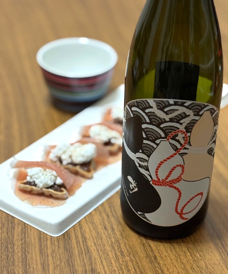 Koimari Saki sake bottle with a beautifully arranged appetizer plate