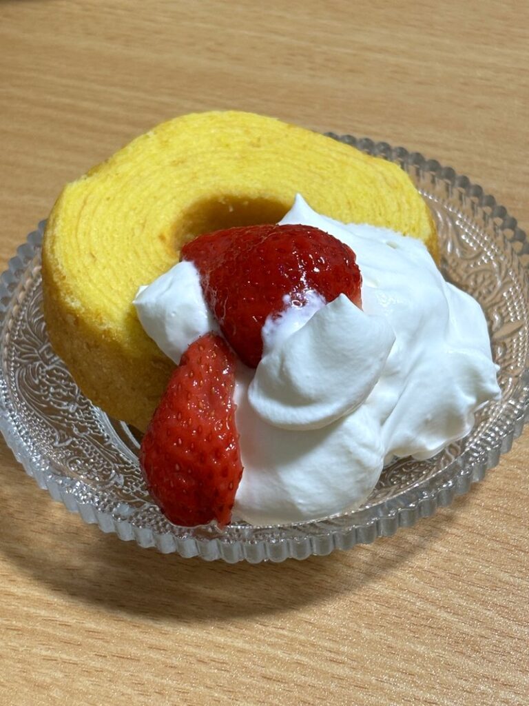 Baumkuchen dessert with strawberries and whipped cream