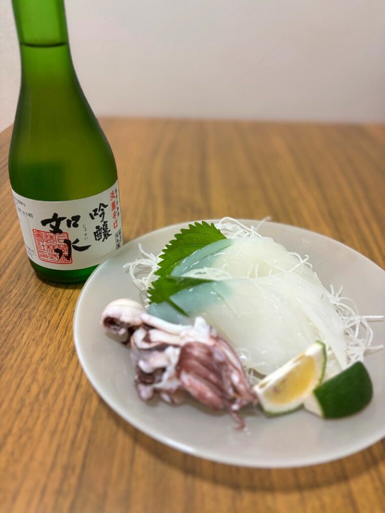 Ginjo sake “Josui” paired with translucent squid sashimi, served with squid tentacles, shiso leaves, and kabosu citrus.