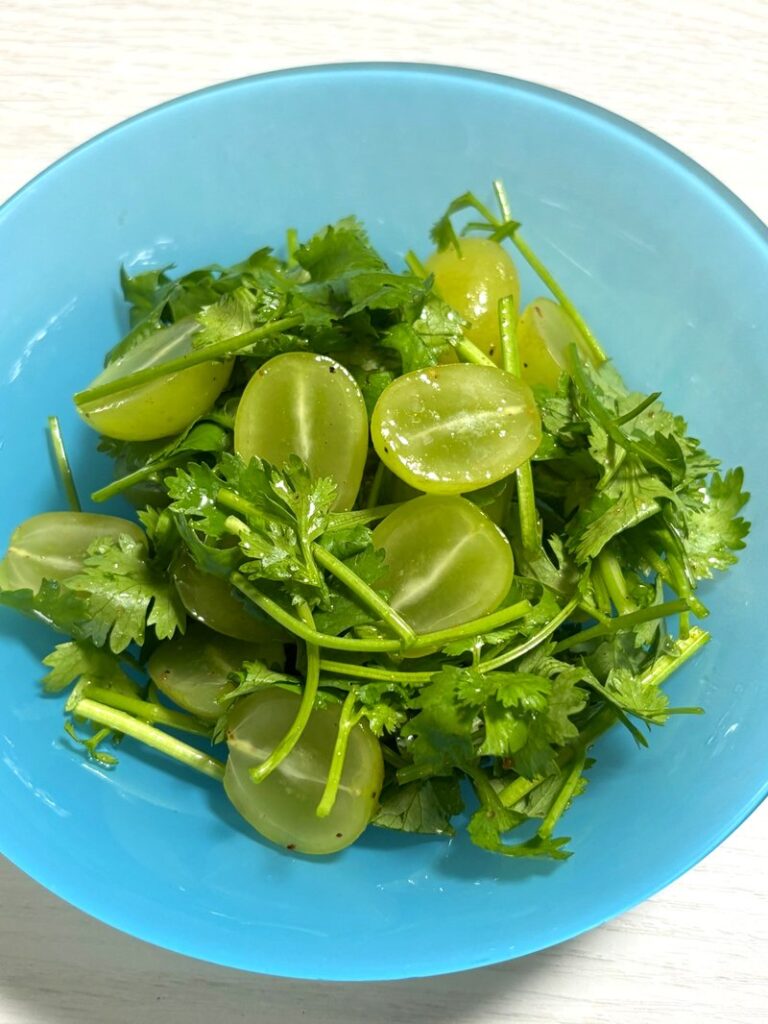Shine Muscat and cilantro salad, with halved grapes tossed in spice and olive oil for a refreshing dish.