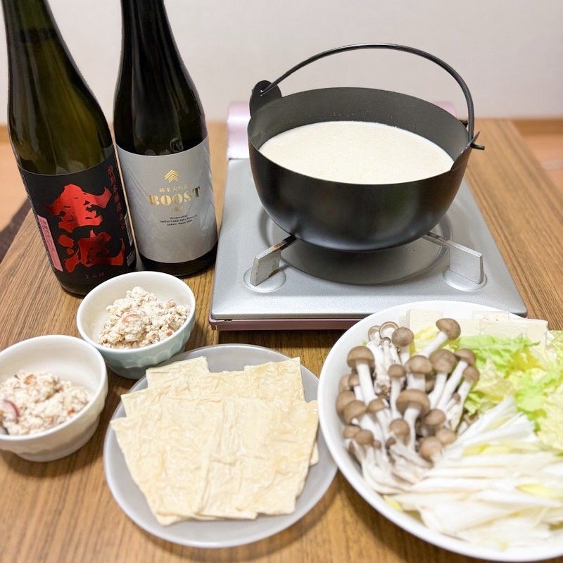 Dinner table featuring Hikari Brewery’s “BOOST” and “Kinpa” sake, with yuba shabu and ginger sake lees tofu salad.