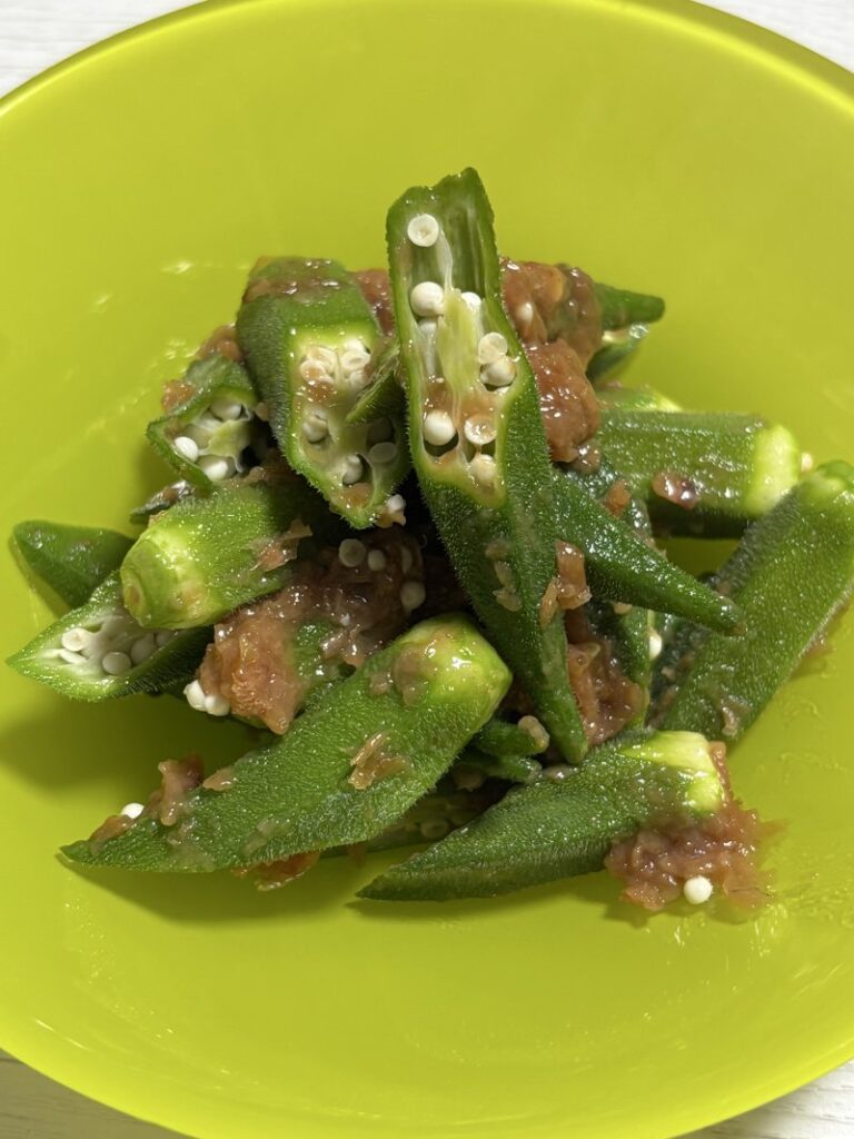 Close-up photo of sliced okra mixed with pickled plum paste