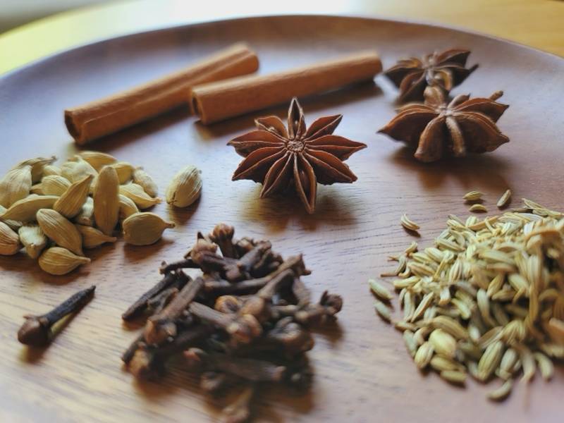 Image of assorted spices such as star anise, cinnamon, and cloves arranged together