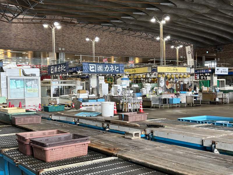 Inside Karato Market near closing time, with stalls being cleared and the market growing quiet