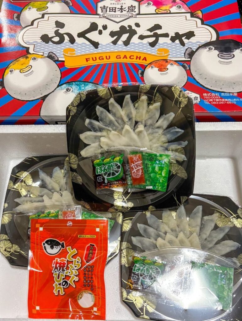 Contents of a “Fugu Gacha” set from Karato Market, featuring fugu sashimi with dipping sauce and condiments