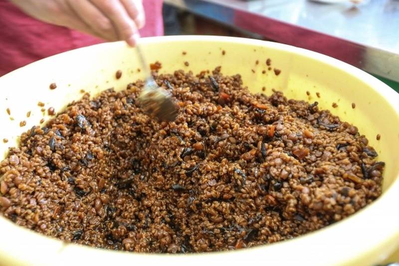 Kanazanjimiso being mixed during preparation, made with chopped vegetables and fermented koji.