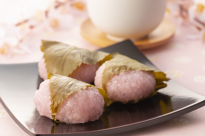 Image of three sakuramochi wrapped in salted cherry leaves.