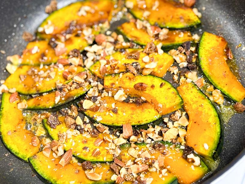 Image of roasted pumpkin slices topped with cinnamon and chopped nuts.