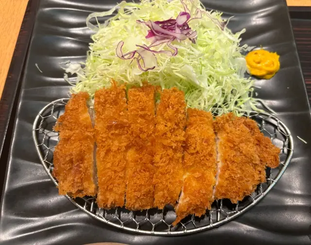 A classic Japanese tonkatsu (breaded pork cutlet) served with shredded cabbage — a beloved combination in everyday Japanese home cooking