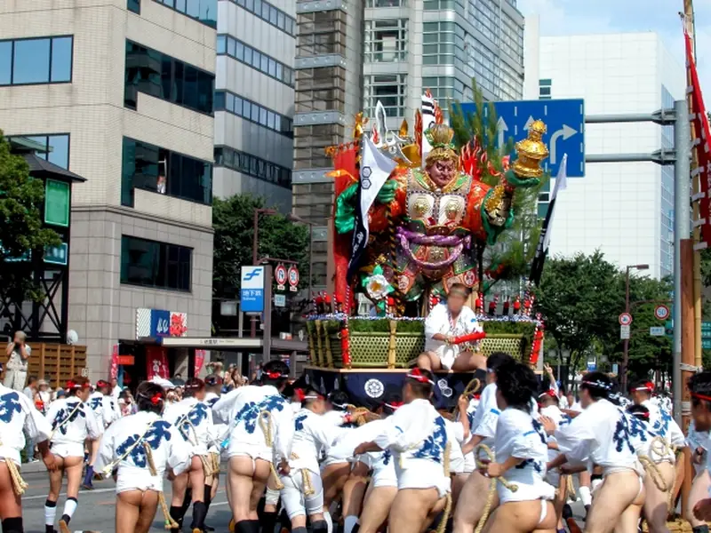 Bearers carrying a festival float through the streets of Hakata