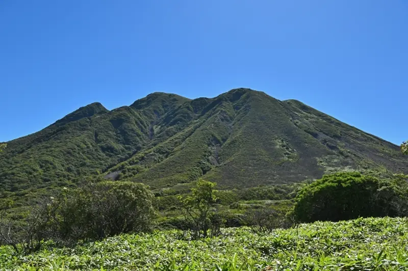 Green Kuju mountain range under a clear blue sky