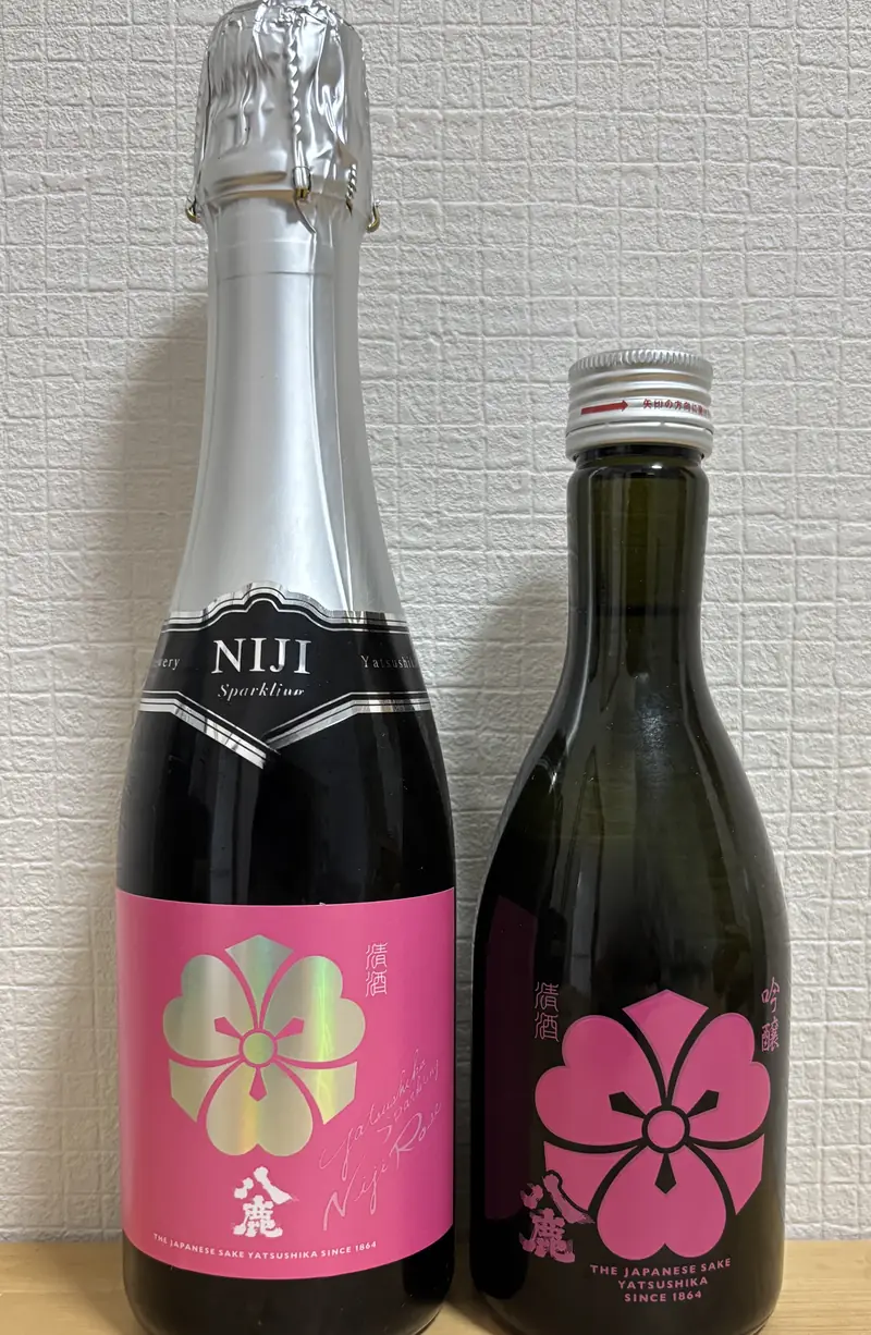 Bottles of Yatsushika Sparkling Niji Rose and Yatsushika Goshu Ginjo Momo side by side